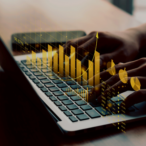 Close-up of hands typing on a laptop keyboard with an overlay of glowing golden financial bar charts and data graphs.