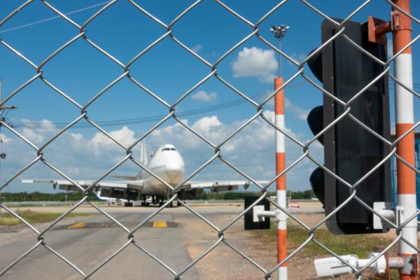 Unauthorized Airport Access A restricted airport access point with aviation security