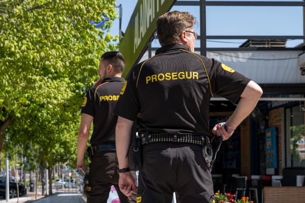 Two Prosegur Armed Guards Two Prosegur security officers providing security guard services for a bank