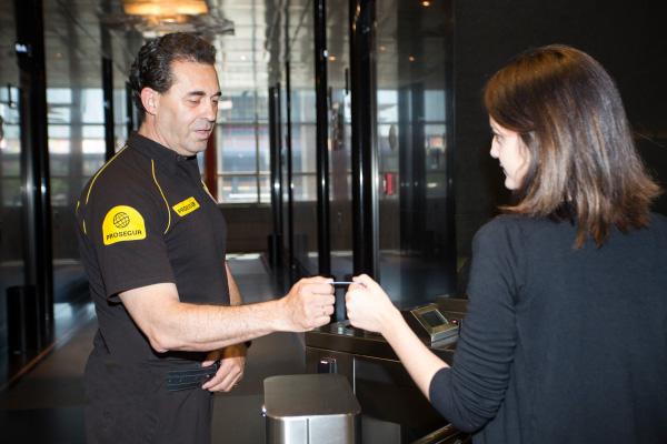 Corporate Campus Access Control A Prosegur officer reviewing the access control credentials for a client