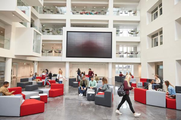 Active College Campus A campus building with students socializing and studying