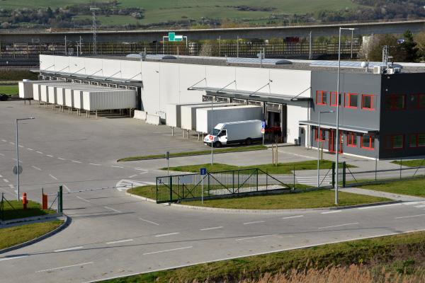 A logistics hub and warehouse with a security gate