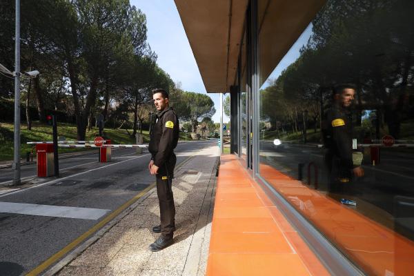 A Prosegur security guard at a security checkpoint blocking access for logistics trucks