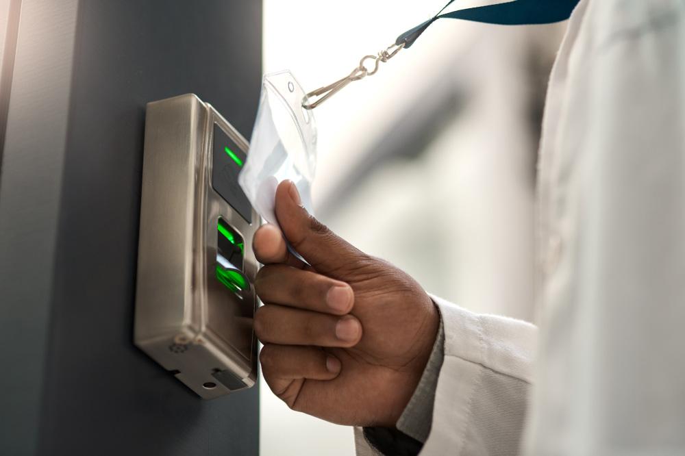 A lab worker entering a secured facility with an access control badge