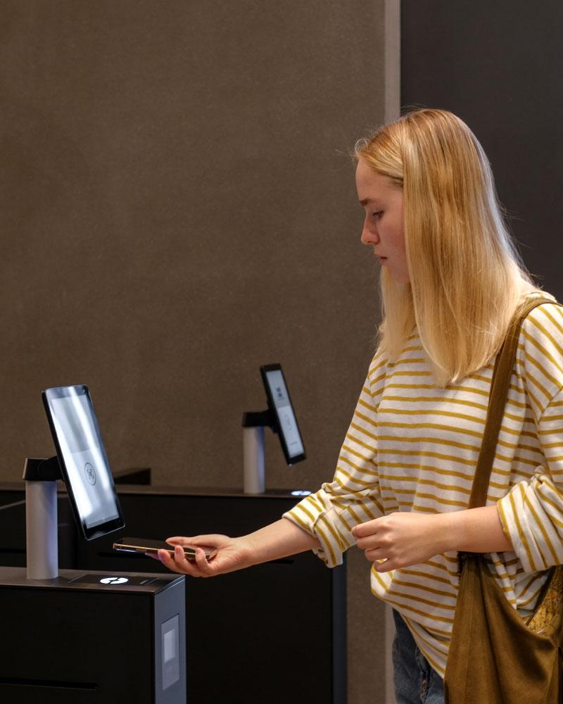 A lady using her phone to get through access control