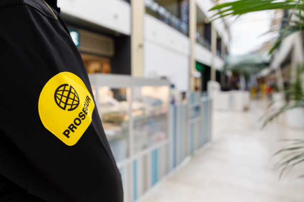 Prosegur security officer on patrol with his uniform badge on display